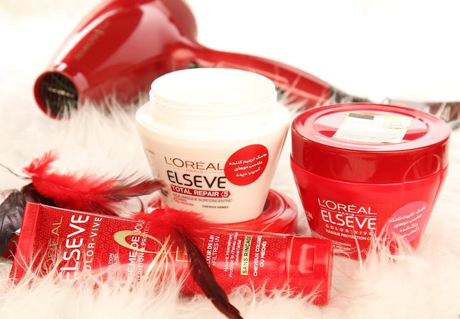 High-quality shot of L'Oreal hair products and hair dryer on white fur background.