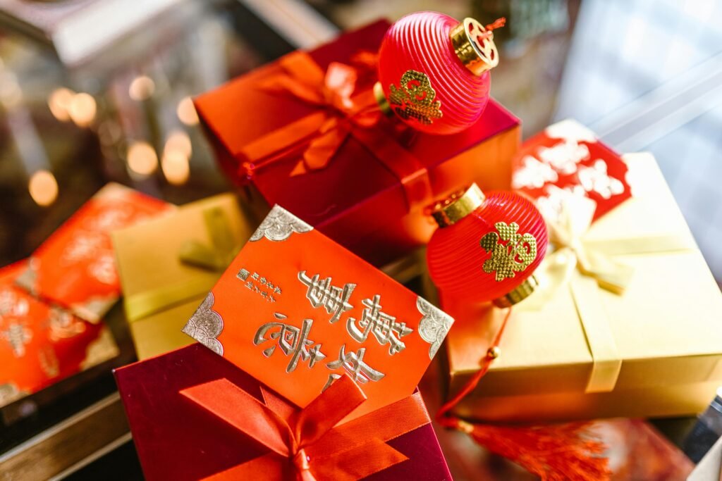 Colorful gift boxes with red packets and lanterns for Chinese New Year celebration.